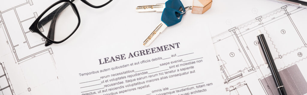 document on a desk with lease agreement lettering near a pair of glasses