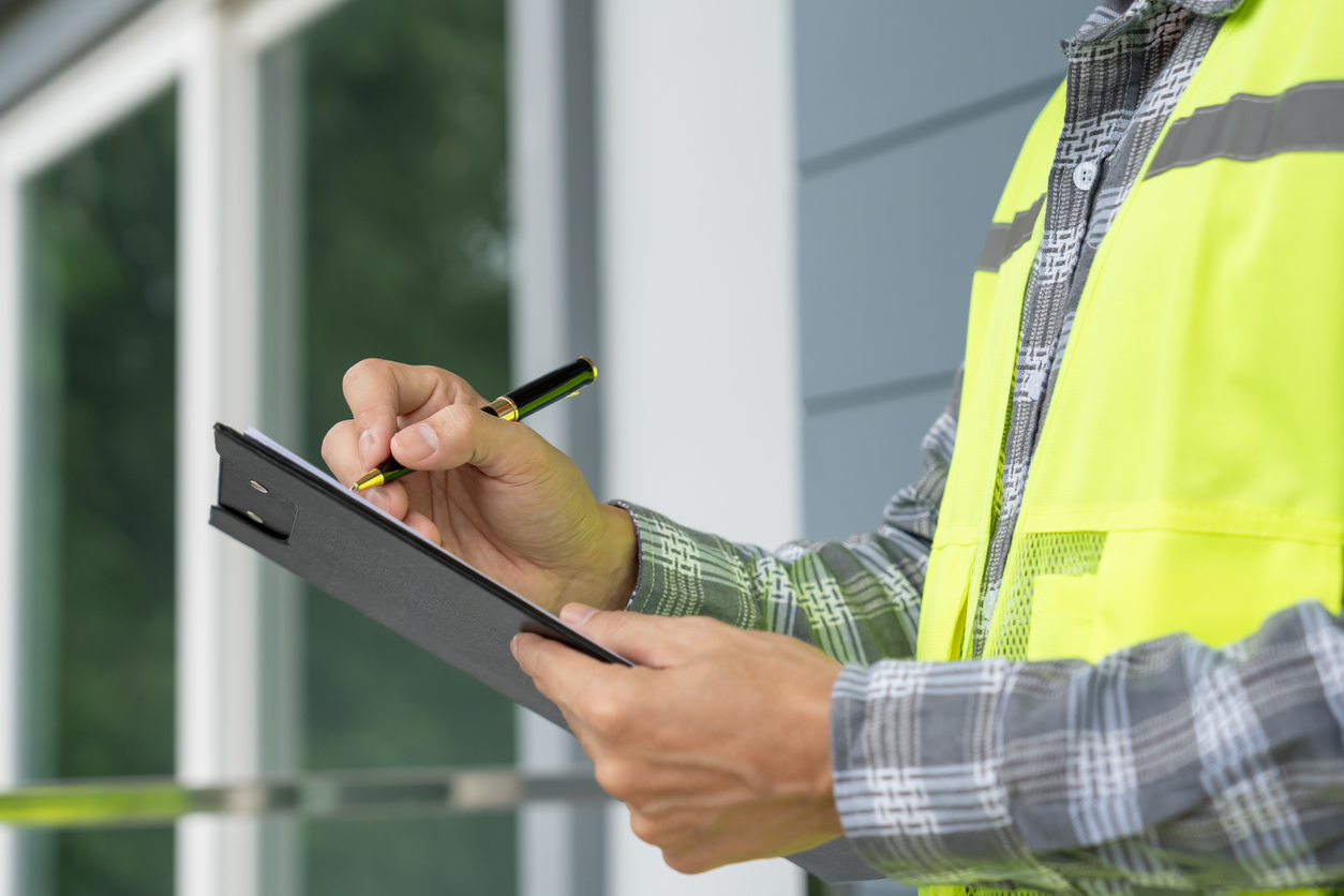inspector inspecting construction and quality assurance new house using a checklist. 
